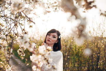 
girl next to a flowering tree