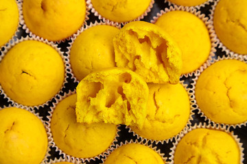 Pumpkin muffins, cupcakes background. Halved cupcake, inside, closeup. Homemade bakery