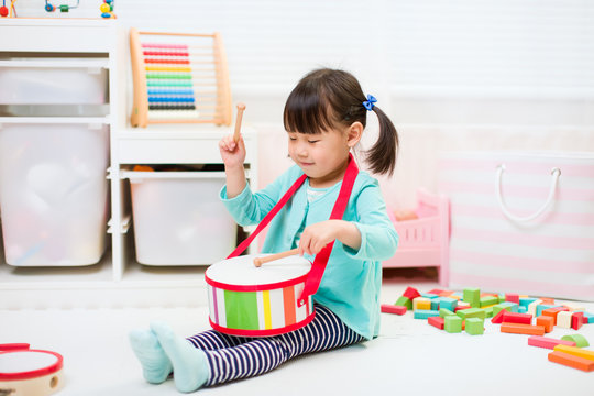 Toddler Girl Play Drum At Home For Homeschooling