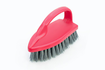 Kitchen red plastic brush in the shape of an iron isolated on a white background