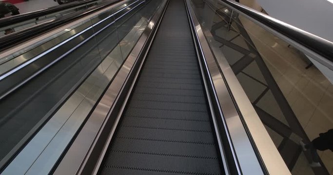 empty escalator in a large multi-storey layered shopping center. view from above