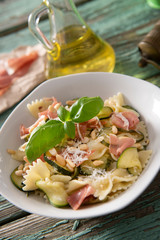 Farfalle pasta with courgette, pine nuts and prosciutto ham