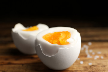 Tasty boiled chicken eggs on wooden table, closeup