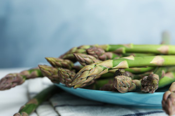 Fresh raw asparagus on table, closeup view