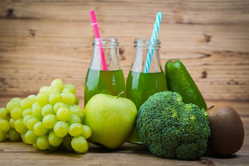 Vegetarian healthy food. Source of protein for vegetarians. Healthy eating: vegetable, broccoli, kiwi, leaf vegetable, apple, grapes, juice on wooden table.