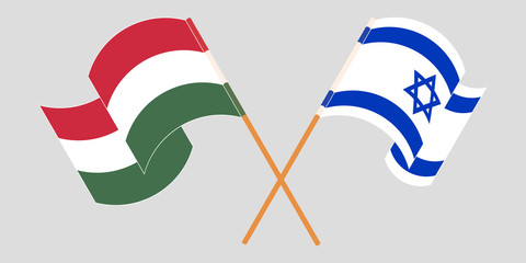 Crossed and waving flags of Hungary and Israel