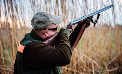 Hunter with a rifle in hunting