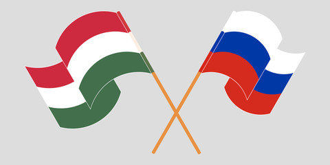 Crossed and waving flags of Hungary and Russia