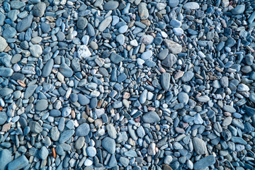 Blue pebbles. Background from a natural stone of blue, turquoise hue. Pebbles texture