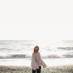 Young happy carefree woman relaxing and enjoying sunset at sea.