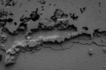 Textured concrete wall background. Rough texture. Cracks in the wall.