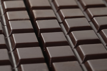 Delicious dark chocolate as background, closeup view