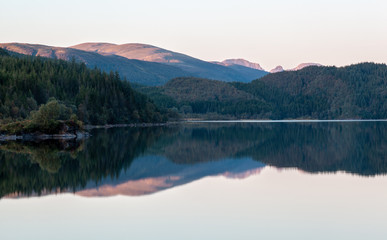 Fototapeta premium The reflection of the hills and woods in the lake.