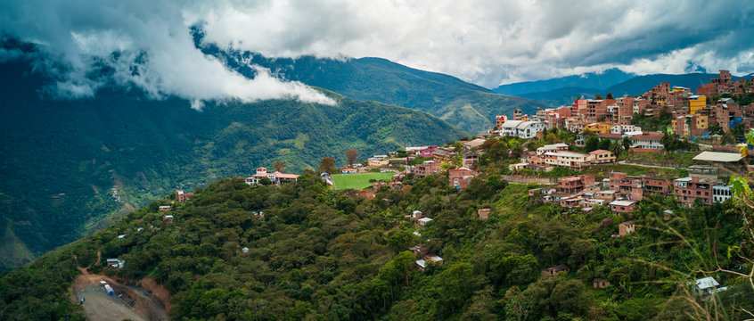 Brick Houses in the Green Hills and a Soccer Field on a Cloudy Day in Coroico, La Paz / Bolivia