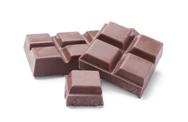 Pieces of delicious milk chocolate isolated on white