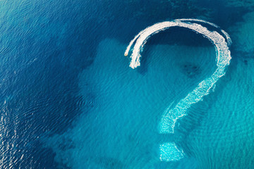 Question mark on tropical sea water surface as symbol of uncertainties end of global quarantine due...