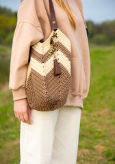 Beige-brown Bag on the shoulder of a girl.