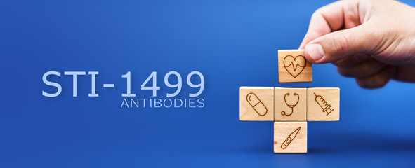 STI-1499 antibody concept. Medical symbols on wooden blocks. problems treating viral diseases