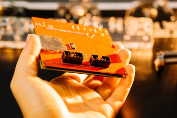 Hand holds display for controlling cnc machine. parts for an engraving machine..