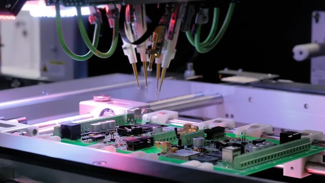 Flying probe test at factory - automation machine equipment for quality testing of printed circuit boards. Automated technology, industrial, robotic, electronic, production, manufacturing concept
