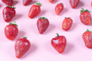 Patern of fresh and juicy red strawberries on pink background