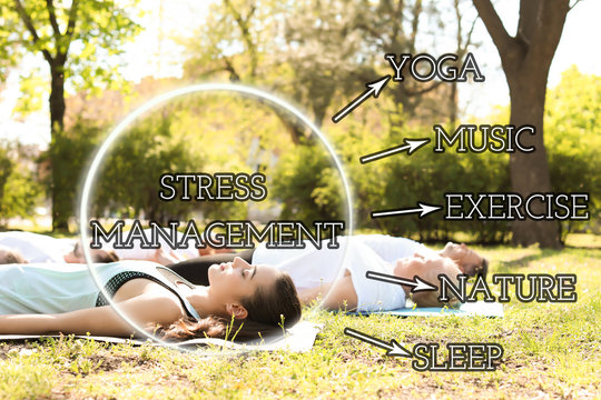 Stress management techniques. Group of people practicing yoga in park