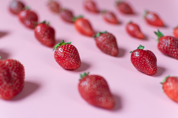 Patern of fresh and juicy red strawberries on pink background