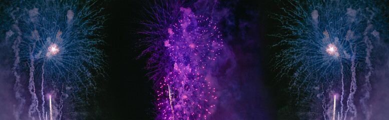 Purple and blue fireworks with smoke over the black sky. Low key exposure. Selective focus.