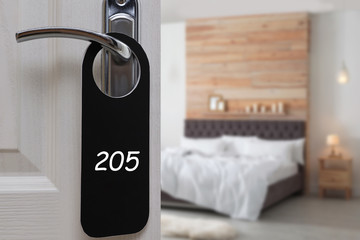 Open door with sign 205 on handle in hotel, closeup. Space for text