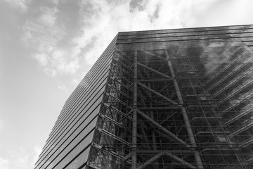 Black and white tone and Close up detail of exterior facade with glass material of modern office buildings, steel structure and high atrium. Abstract Architectural Geometry of Urban metropolis.