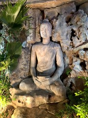 Buddhist statue on the background of the wall