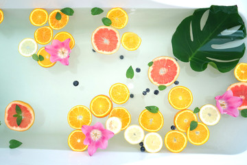 Relaxing bath with fresh fruits and flowers.