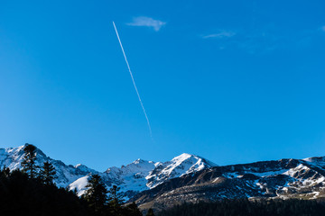 A picturesque landscape view of the high snow capped Pyrenees mountain range on a sunny winter day...