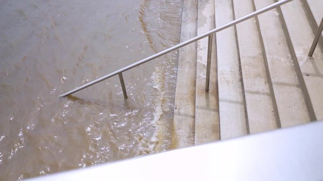 High water flooding on city area walkway after heavy rains and sever weather showing after affects of natural disaster