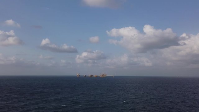 Central processing platform (cpp) in the middle of the ocean on sunny day - upstream industry
