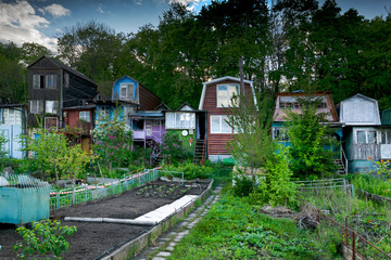 Multi-colored small houses with a clock like in Wonderland