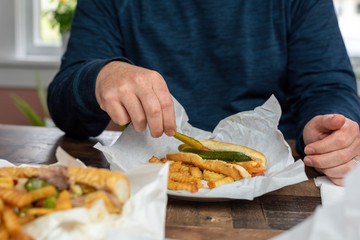 Closeup of a man eating takeout for lunch