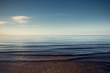 Obraz premium Beautiful light sunset over Baltic sea. Natural background. Latvia. Afterglow, evening calm on the Sea