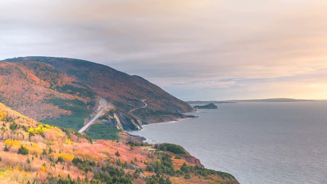 A timelapse of the Cabot Trail during sunset with dramatic clouds overlooking the Atlantic Ocean and the highway