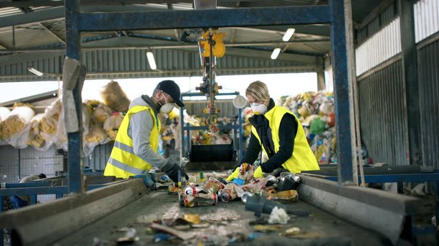 Man and woman workers on landfill, waste management and environmental concept.