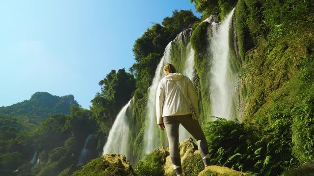 Rear View of Standing Tourist Looking at View of Ban Gioc Waterfall in Cao Bang, Vietnam