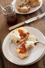 Tasty snack of a raisin scone and cream