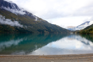 Beautiful norwegian landscape in autumn near Loen and Stryn in Norway.Lake with turquoise water surruonded by mountains.Lovatnet in autumn,photo for printing on calendar,poster,wallpaper,postcard