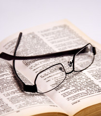 Spectacles on an opened book