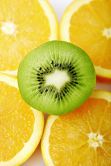 Halved kiwi fruit on four slices of orange