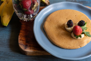 hot cakes or pancakes with red berries, strawberries, blackberries for breakfast, top view, horizontal