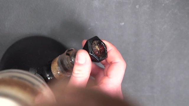 Removing The Bowl From The Glass Bong - Filtration Device For Smoking Cannabis - top down shot