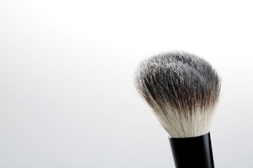 A blusher brush with powder on it