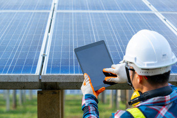 Engineer checking solar panel in routine operation at solar power plant,Solar power plant to...