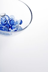 Blue and clear colour beads in a glass bowl